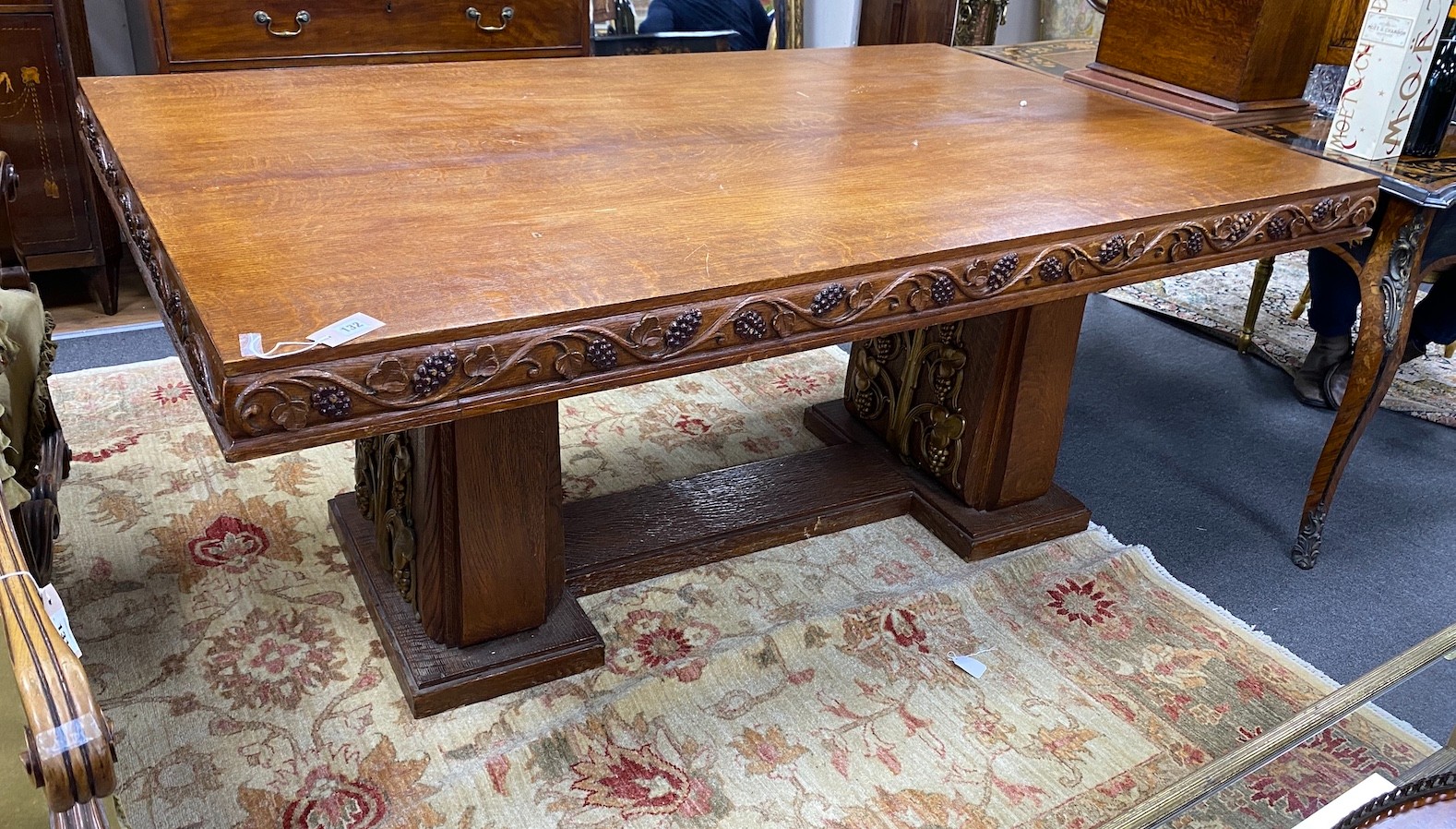 An early 20th century gilt bronze mounted rectangular oak dining table with carved fruiting vine decoration, width 180cm, depth 113cm, height 75cm